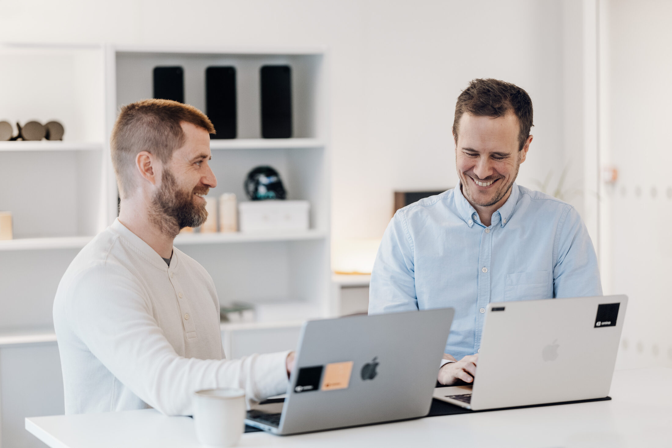 Amina team members Johan Olofsson VP Software and Øystein Tveterås Product Manager collaborating on EV charger software development at Amina office