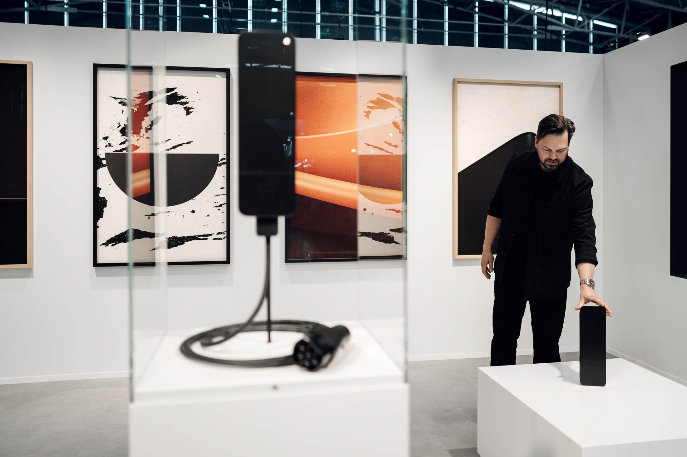 Jone Fredriksen, Product Manager at amina, holding an amina EV charger, highlighting product development and hardware expertise behind scalable charging solutions.