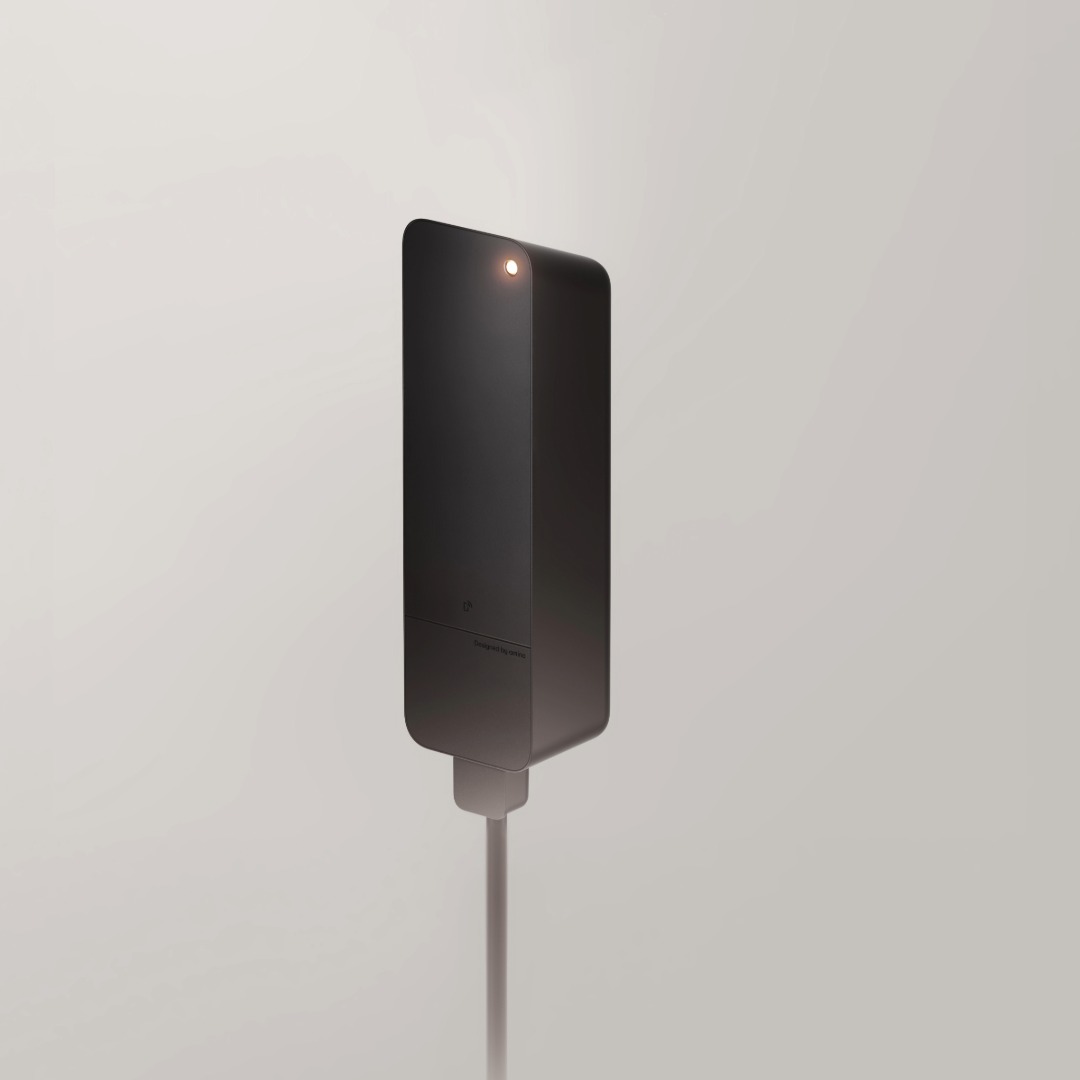 Black amina M wall-mounted EV charger product shot on light background