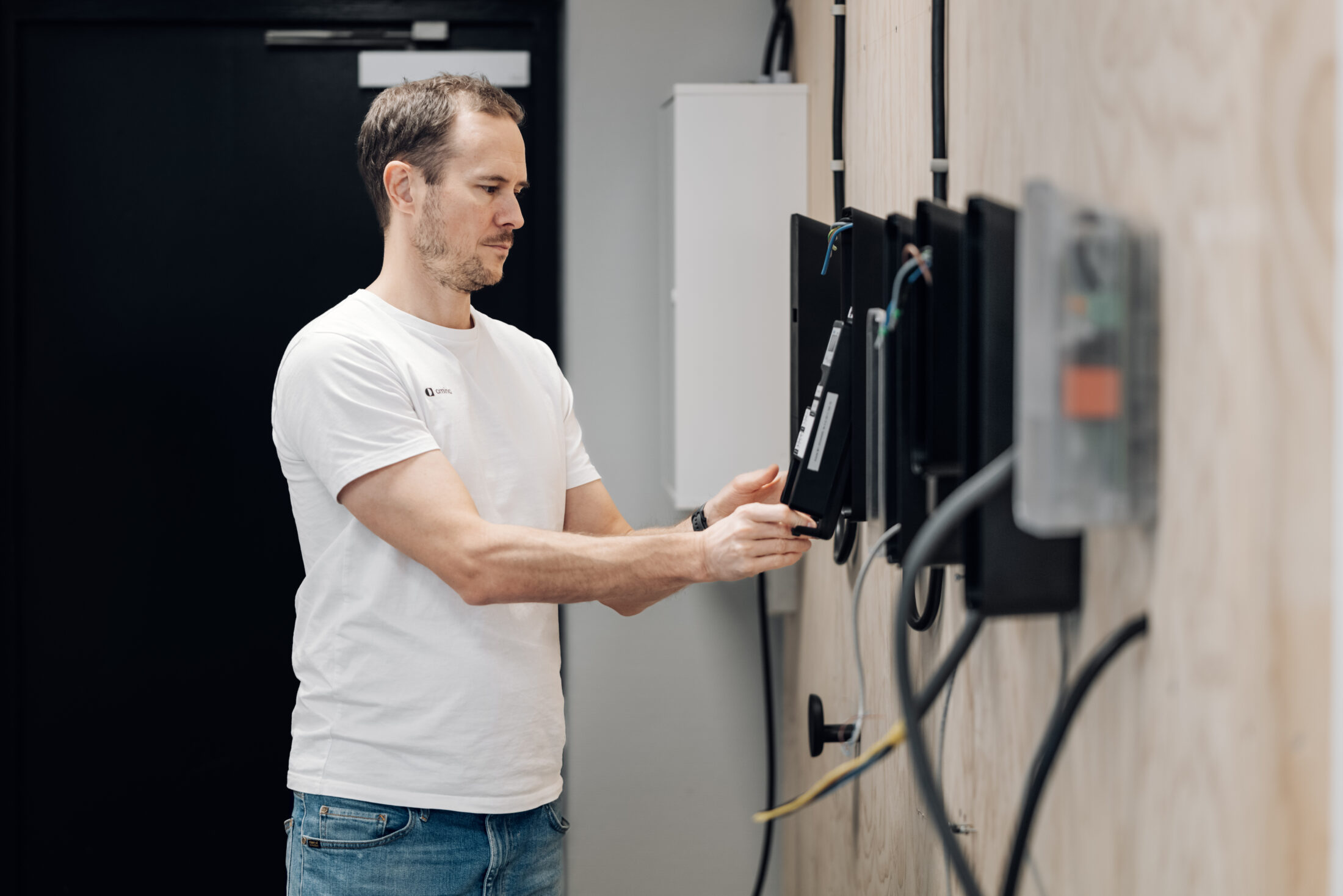 Technician installing home EV charger unit with MID-compliant amina equipment