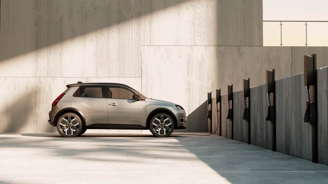 Multiple amina M wall-mounted EV chargers installed along a concrete wall, charging electric cars in a shared outdoor parking area, demonstrating scalable multi-dwelling charging infrastructure.